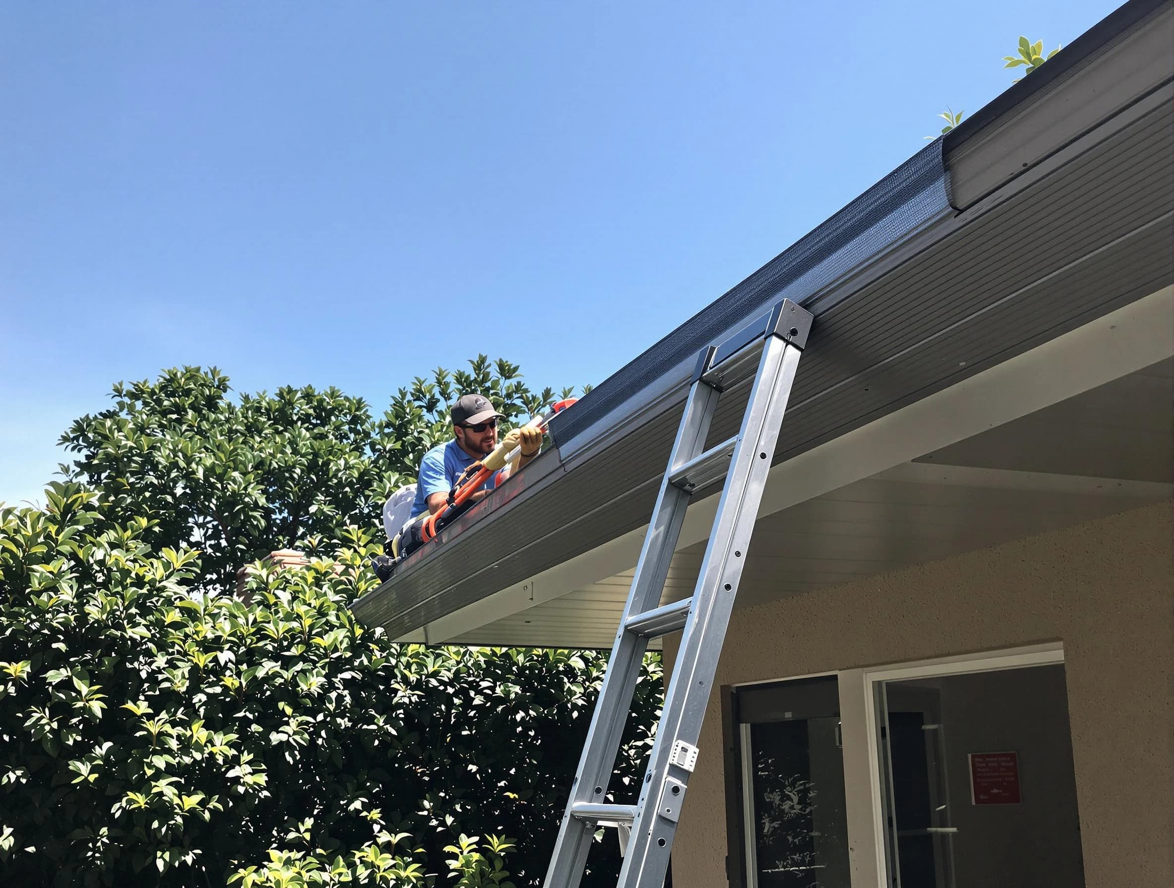 Berea Roofing Company installing gutter guards for a homeowner in Berea, OH